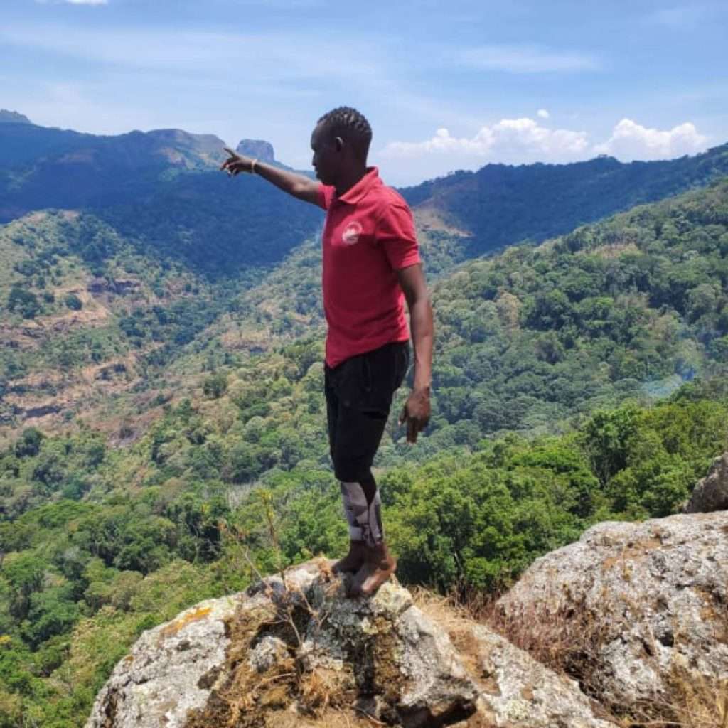 A guide of Elgon Safaris pointing out directions on Mount Kadam